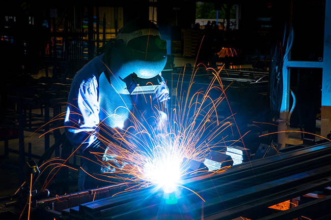 Image of a welder in safety equipment.
